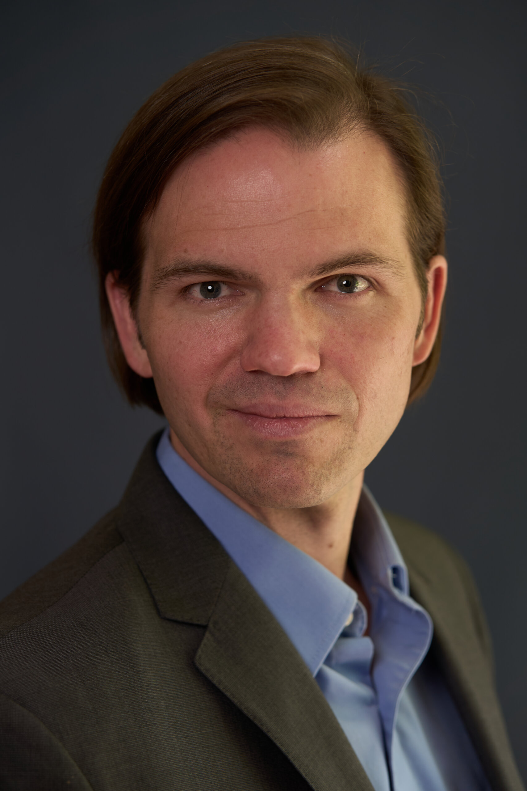 Professional business headshot of Zane Kennedy in a jacket, photographed by Charlotte Pro Photography