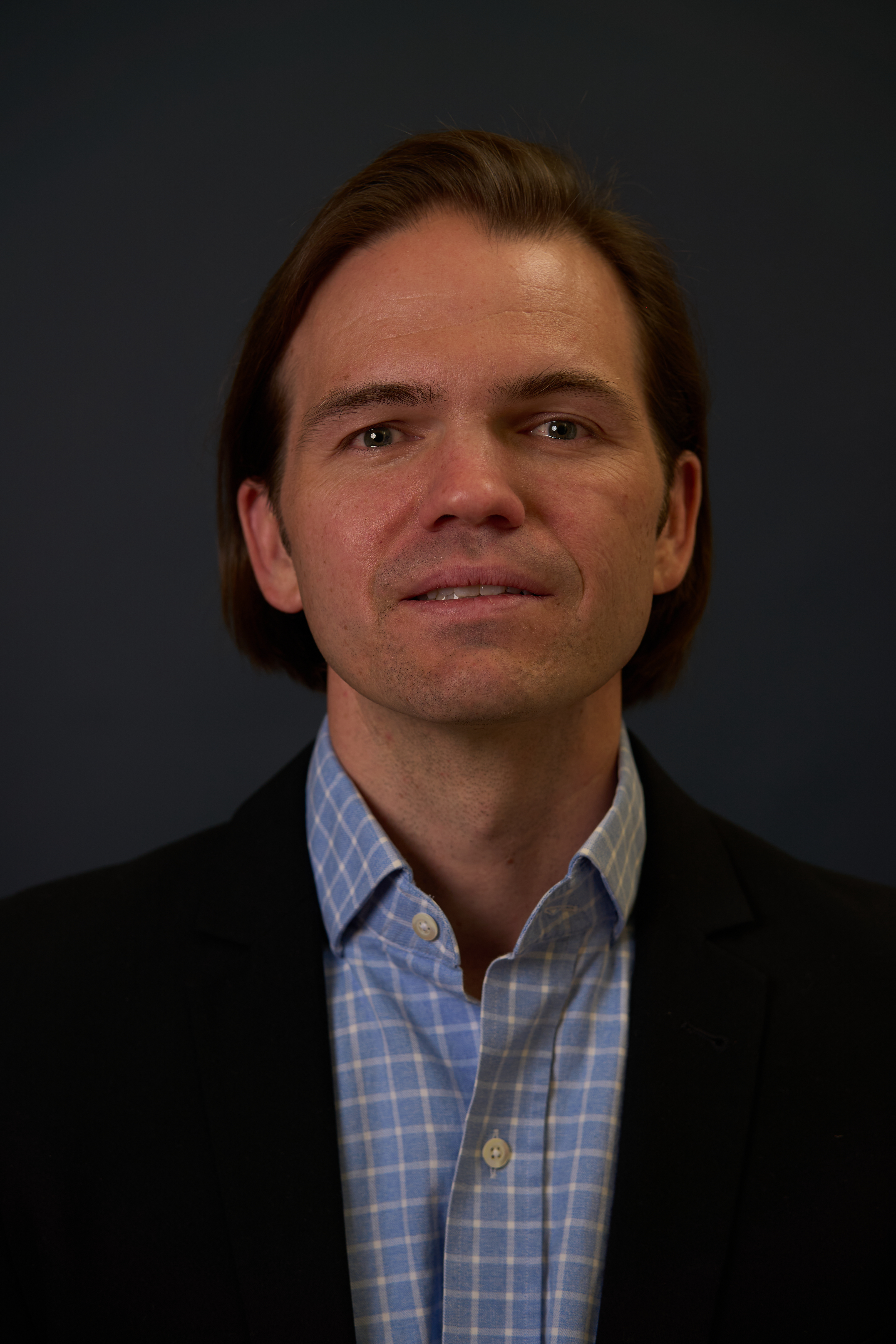 Theatrical actor headshot of Zane in a dark suit, photographed in Charlotte